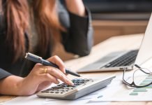 Essential Security Features for a Reliable Document Management System Close up of female accountant or banker making calculations. Sav